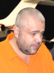 Paul Le Roux escorted by DEA agents (cropped)